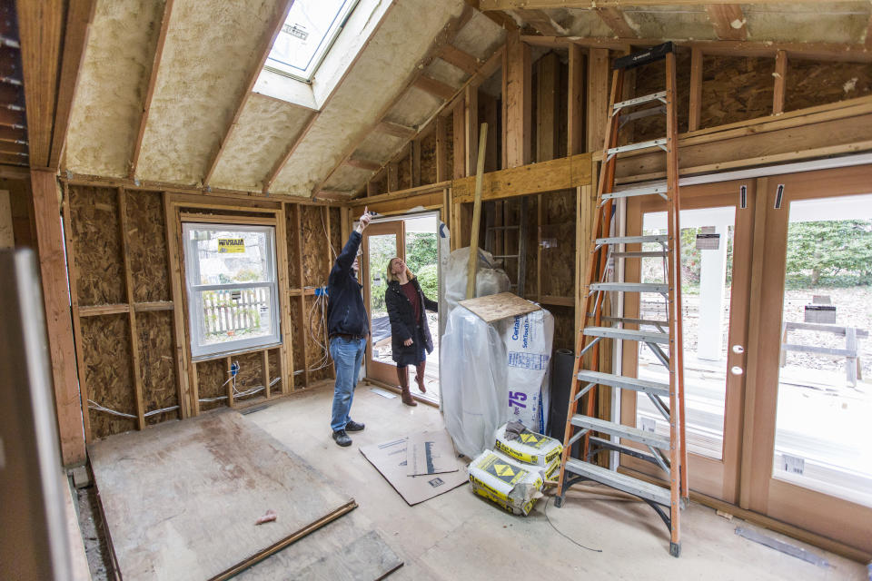 Howard Bass and Lisette Voyatzis look over the progress of a $400,000 comprehensive renovation of their home in Arlington, Va. Americans are spending lavishly again to upgrade their homes, a clear indication that consumers are confident that the housing recovery will continue. Homeowners spent $120 billion on remodeling projects last year, according to data released yesterday by the U.S. Census Bureau. (Photo by Brooks Kraft LLC/Corbis via Getty Images)